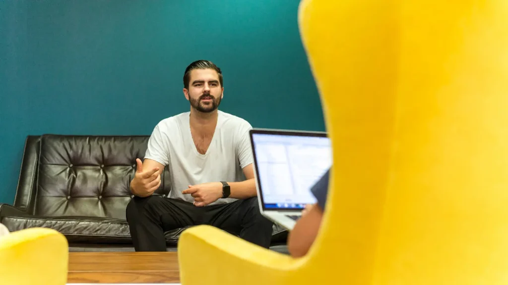 Candidate speaking with an interviewer across a desk